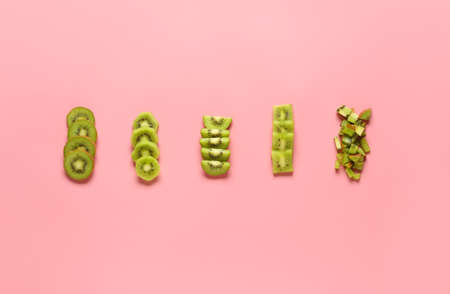 Cut ripe kiwi on color background