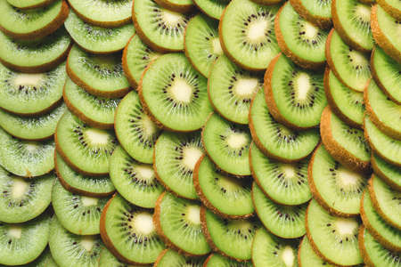 Many cut kiwi as backgroundの写真素材