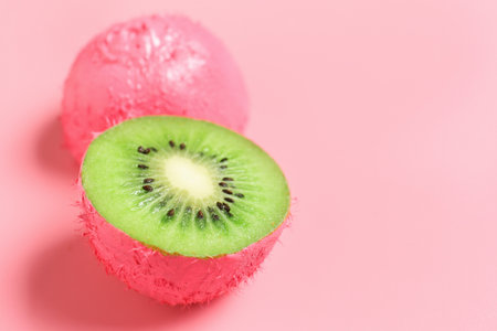 Painted cut kiwi on color backgroundの写真素材