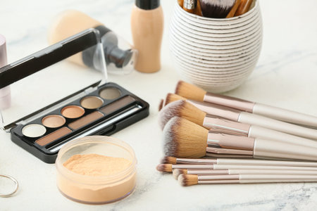Set of makeup brushes and decorative cosmetics on dressing tableの写真素材