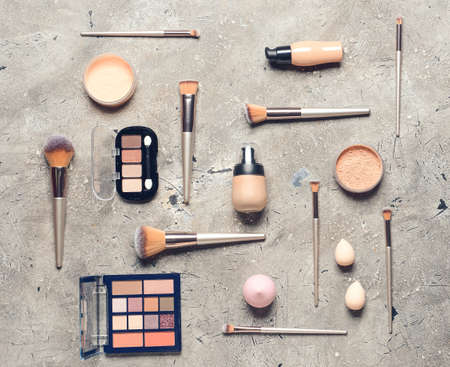 Set of makeup brushes, sponges and decorative cosmetics on grunge backgroundの写真素材