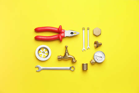 Set of plumber's items on color backgroundの写真素材