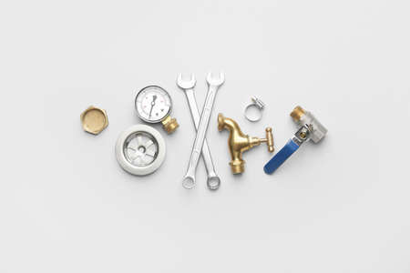 Set of plumber's items on light backgroundの写真素材