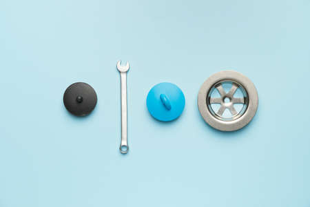 Set of plumber's items on color background