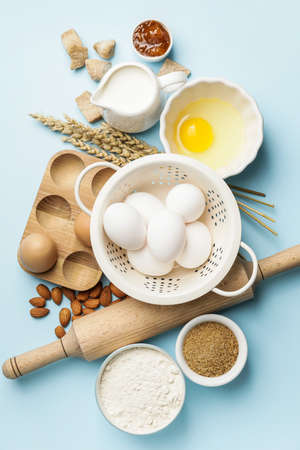 Ingredients for preparing bakery and kitchen utensils on color background