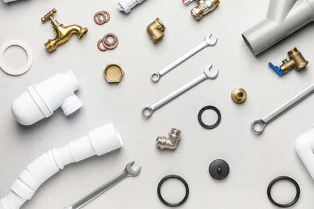 Set of plumber's items on light backgroundの写真素材
