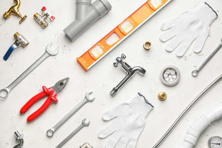 Set of plumber's items on light backgroundの写真素材