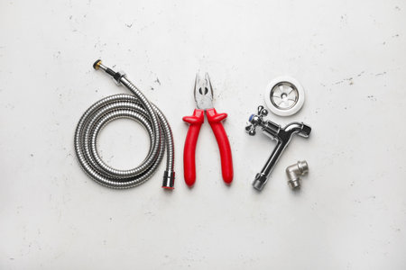 Set of plumber's items on light backgroundの写真素材