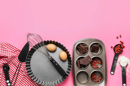 Ingredients for preparing bakery and kitchen utensils on color backgroundの写真素材