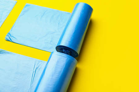 Rolls of garbage bags on color backgroundの写真素材