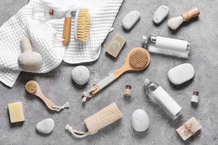 Composition with massage brushes and bath supplies on grunge background