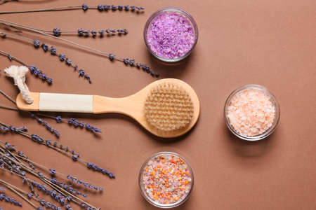 Composition with massage brush, sea salt and lavender flowers on color backgroundの写真素材