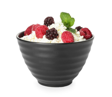 Bowl of cottage cheese with raspberries and blackberries on white backgroundの写真素材
