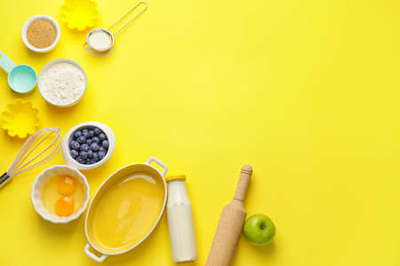 Ingredients for preparing bakery and kitchen utensils on color backgroundの写真素材
