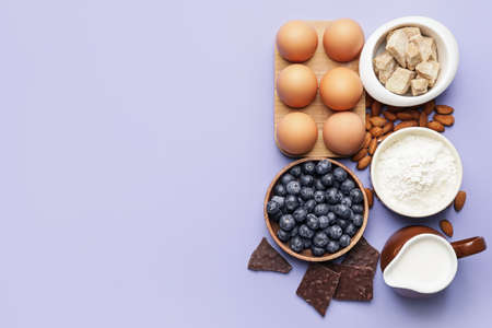 Ingredients for preparing bakery and kitchen utensils on color backgroundの写真素材