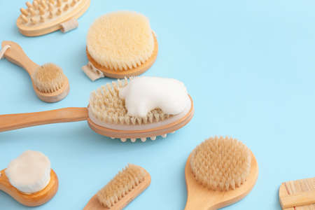 Different massage brushes on color background