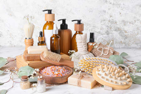 Composition with massage brushes and bath supplies on light backgroundの写真素材