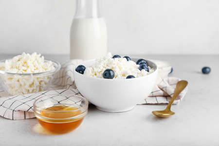 Bowl of cottage cheese with blueberries on light backgroundの写真素材