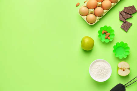 Ingredients for preparing bakery and kitchen utensils on color background