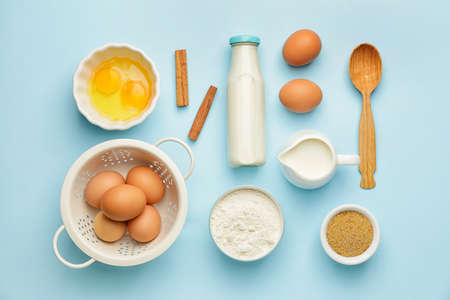 Ingredients for preparing bakery and kitchen utensils on color backgroundの写真素材