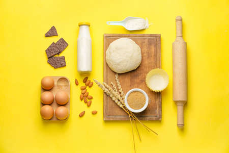 Ingredients for preparing bakery and kitchen utensils on color backgroundの写真素材