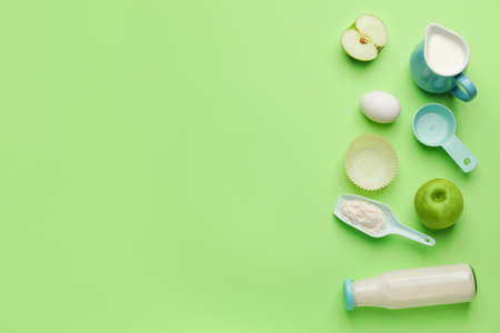 Ingredients for preparing bakery and kitchen utensils on color backgroundの写真素材