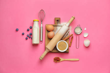Ingredients for preparing bakery and kitchen utensils on color backgroundの写真素材