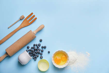 Ingredients for preparing bakery and kitchen utensils on color backgroundの写真素材