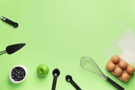 Ingredients for preparing bakery and kitchen utensils on color backgroundの写真素材