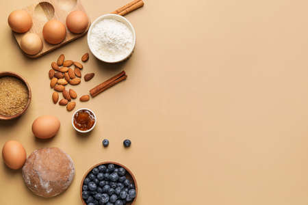 Ingredients for preparing bakery and kitchen utensils on color backgroundの写真素材