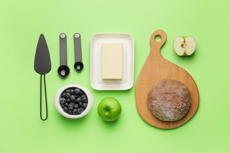 Ingredients for preparing bakery and kitchen utensils on color backgroundの写真素材