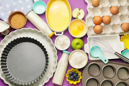 Ingredients for preparing bakery and kitchen utensils on color backgroundの写真素材