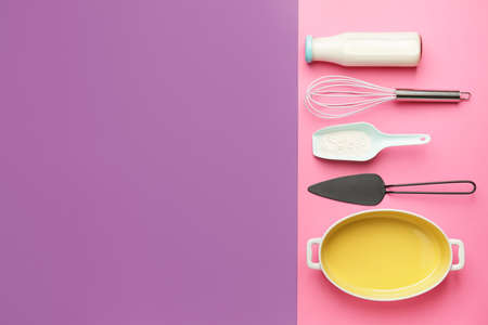 Ingredients for preparing bakery and kitchen utensils on color background