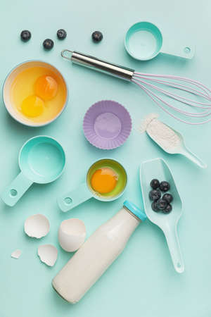 Ingredients for preparing bakery and kitchen utensils on color backgroundの写真素材