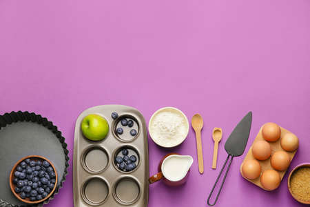 Ingredients for preparing bakery and kitchen utensils on color backgroundの写真素材