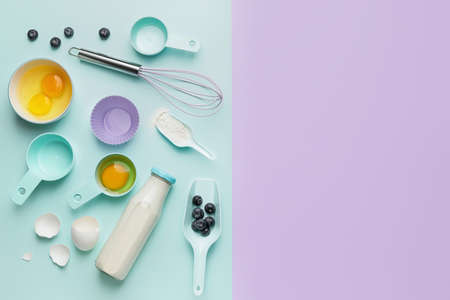 Ingredients for preparing bakery and kitchen utensils on color backgroundの写真素材