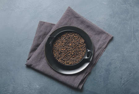Plate with peppercorns on color backgroundの写真素材