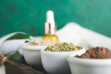 Dry henna powder in bowls on color background, closeupの写真素材