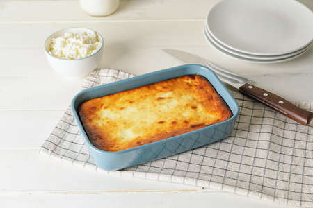 Dish with tasty cottage cheese casserole on white wooden backgroundの写真素材