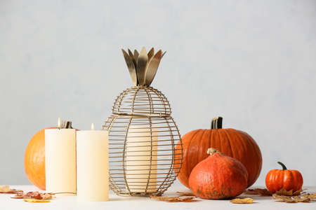 Candles with pumpkins on light backgroundの写真素材