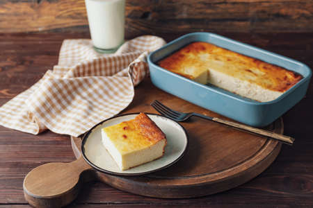Plate with piece of cottage cheese casserole on tableの写真素材