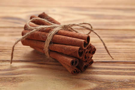 Cinnamon sticks on wooden backgroundの写真素材