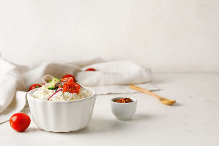 Bowl with cottage cheese on light backgroundの写真素材