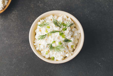 Bowl with cottage cheese on dark backgroundの写真素材