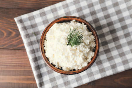 Bowl with cottage cheese on wooden backgroundの写真素材