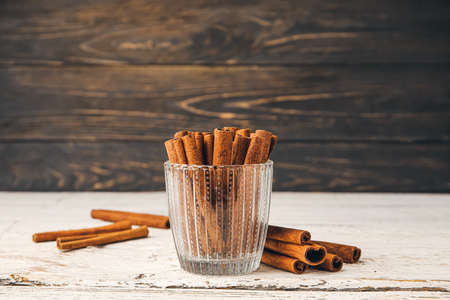 Cinnamon sticks in cup on tableの写真素材