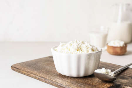 Bowl with cottage cheese on light backgroundの写真素材