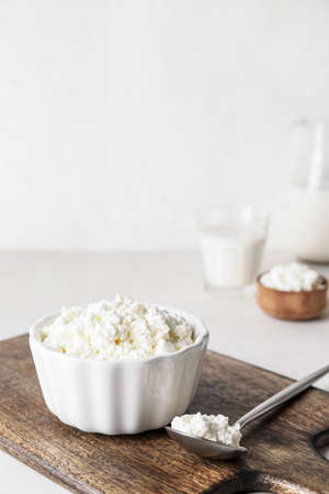 Bowl with cottage cheese on light backgroundの写真素材
