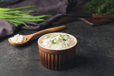 Bowl with cottage cheese on dark backgroundの写真素材