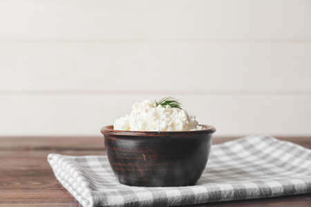Bowl with cottage cheese on wooden backgroundの写真素材